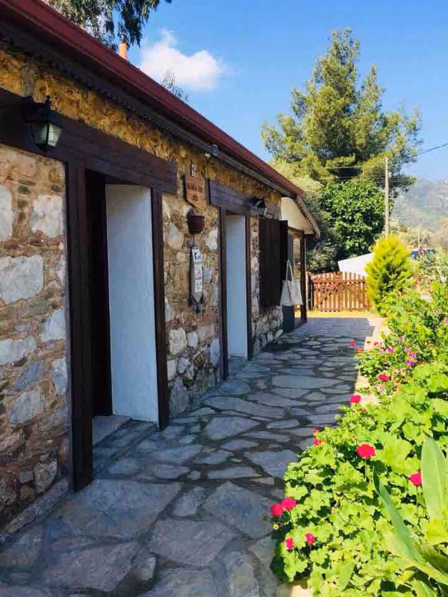 Begonvilli Konak — pembe begonvillerle bezeli taş cephe